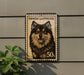 A wooden postcard featuring a picture of a Finnish Lapphund dog, with the text "FINISH LAPPHUND" and "50s" printed on it.