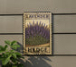 A framed image of lavender flowers is mounted on a wall, with the word "HEDGE" written below the image.