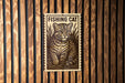A sign featuring a cat, with the text "FISHING CAT" prominently displayed.
