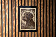 A stamp featuring a dog's head on a wooden background.
