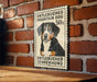 a poster of a dog, specifically a Bernese mountain dog, mounted on a brick wall.