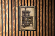A vintage-style stove is depicted on a wooden wall, with a black and white illustration of the stove.