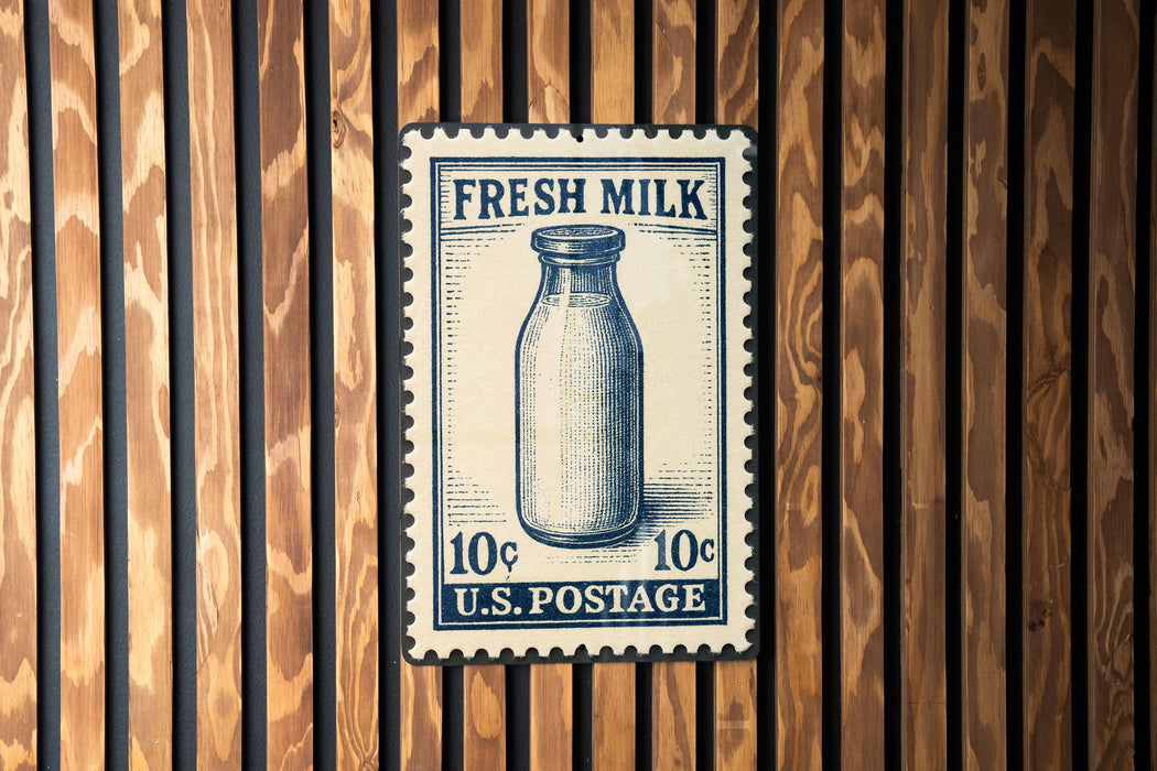 A vintage-style postage stamp featuring a milk bottle, mounted on a wooden wall.