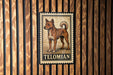 A metal sign with a dog illustration and the word "TELIBIAN" printed on it is displayed on a wooden wall.