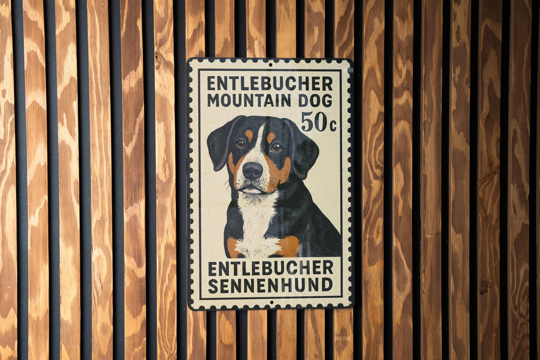 A metal sign with a picture of a dog, mounted on a wooden wall.