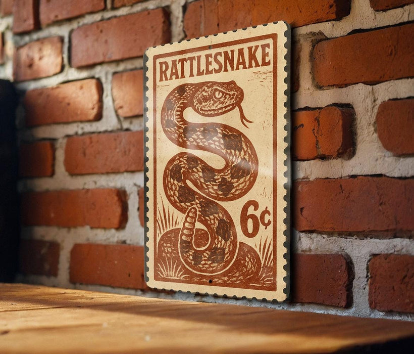 A wooden table with a brick wall in the background, featuring a vintage-style stamp or postcard with a snake illustration and the text "Rattlesnake 6c".
