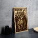 a wooden sign with a cat illustration, placed on a table next to some black camera lenses.