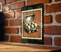 A sign featuring an illustration of a carton of eggs mounted on a brick wall.
