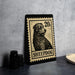 A metal stamp featuring a sheepdog, with the text "SHEEPDOG" printed on it, is displayed on a table.