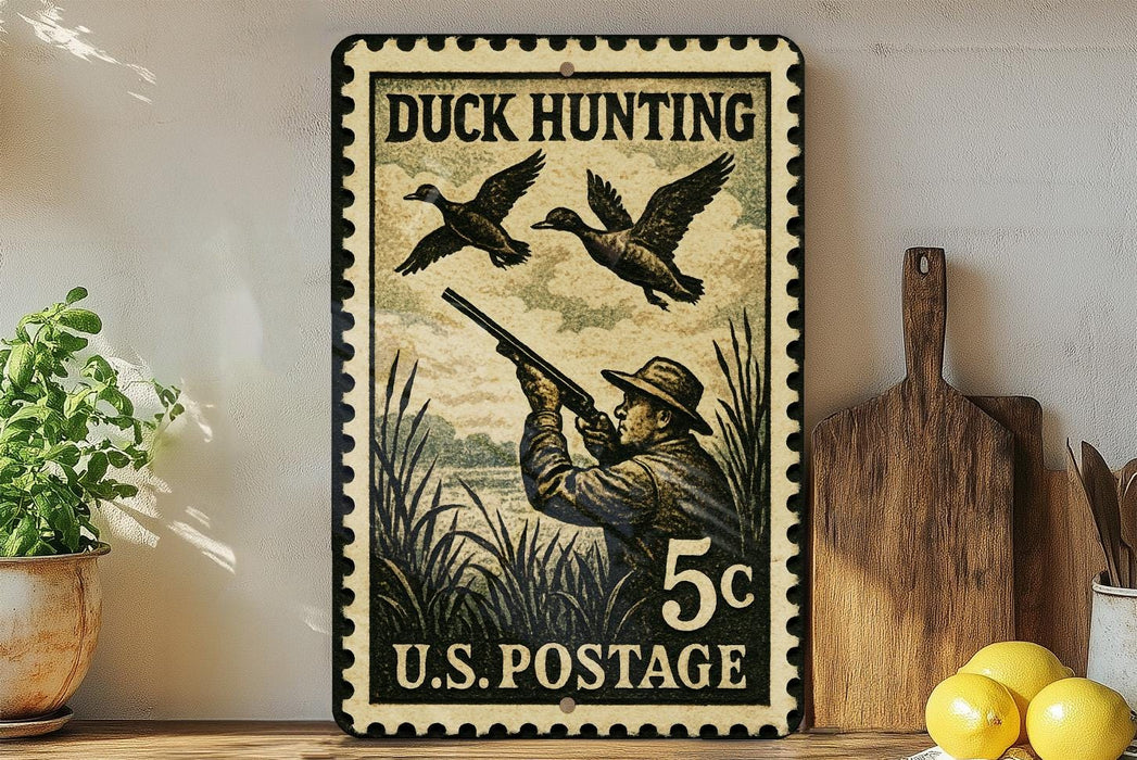 A vintage-style stamp depicting a man hunting ducks, with the text "DUCK HUNTING 5c U.S. POSTAGE" printed on it. The stamp is placed on a shelf next to a wooden cutting board and a potted plant.