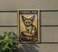 a Fennec Fox, a small desert fox, depicted on a postage stamp-like plaque mounted on a wall.