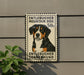 a sign with a picture of a dog, specifically a Bernese Mountain Dog, mounted on a wall.