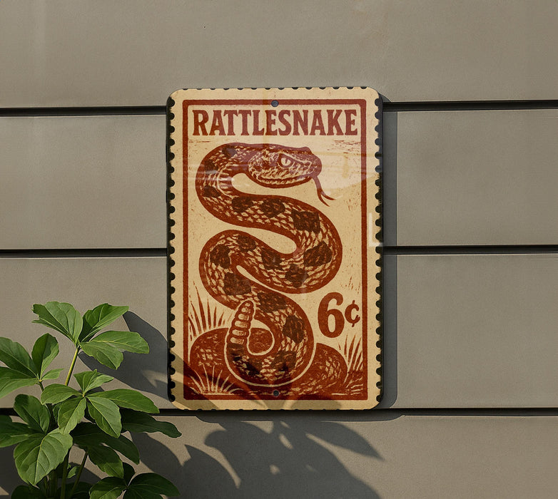 A vintage-style sign for a rattlesnake, featuring a large image of a rattlesnake and the text "Rattlesnake" and "6¢".