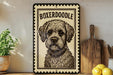 A framed illustration of a Boxeroodle dog is displayed on a shelf, accompanied by a wooden cutting board and a potted plant.