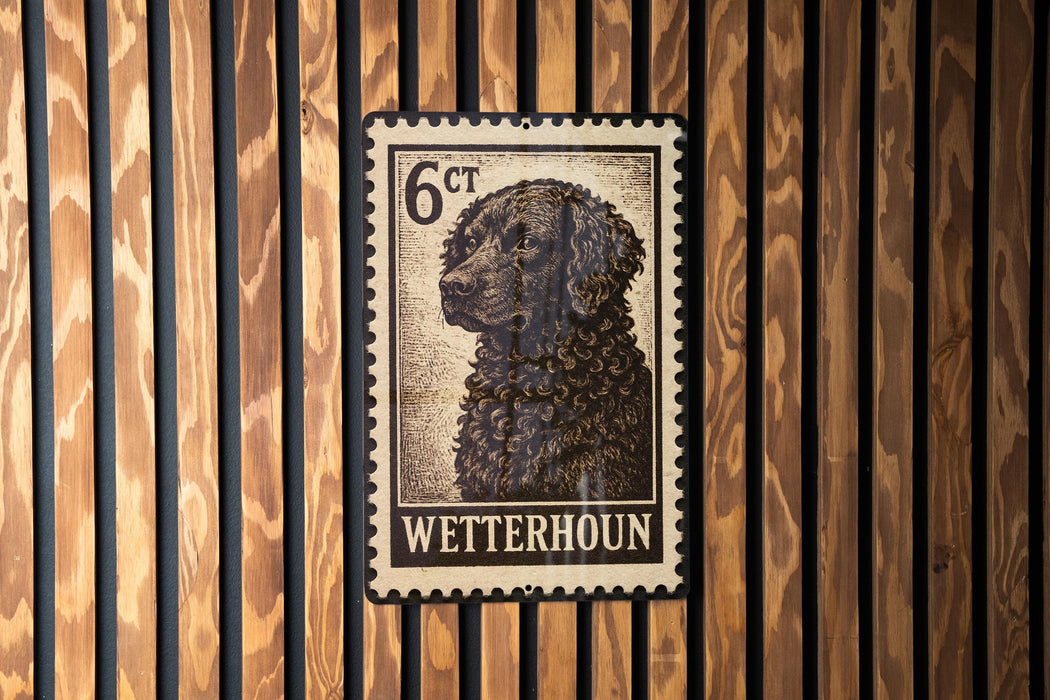 A metal sign with a black and white image of a dog, mounted on a wooden wall.