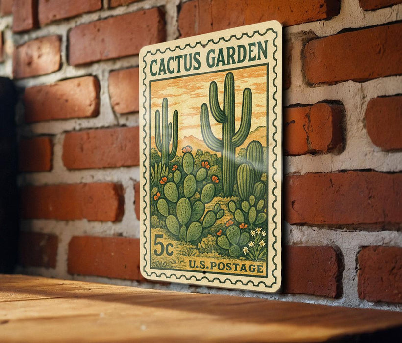 A vintage U.S. postage stamp featuring a cactus garden illustration is displayed on a brick wall.