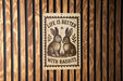 a sign with the text "Life is better with rabbits" and an illustration of two rabbits sitting together.