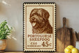 a Portuguese Sheepad Dog stamp, which is a type of postage stamp that is used to send letters or parcels. The stamp is placed on a shelf next to a wooden cutting board and some lemons.