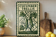 a decorative sign with a cucumber trellis design, placed on a wooden shelf next to a potted plant and a wooden cutting board.