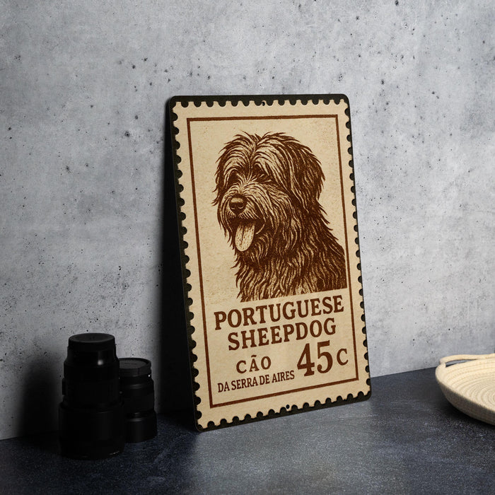 A metal stamp featuring a close-up of a Portuguese Sheepad dog, with text indicating the stamp's origin and value.
