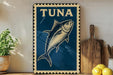A blue and white sign with a fish illustration, placed on a wooden surface next to a wooden cutting board and some lemons.