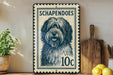 A blue and white postage stamp featuring a dog's portrait is displayed on a shelf next to kitchen utensils and a potted plant.