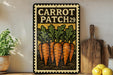 a vintage-style metal sign with a carrot patch design, placed on a wooden surface next to a wooden cutting board and some potted plants.
