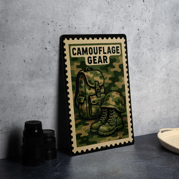 A metal sign with a camouflage pattern and the text "CAMOUFLAGE GEAR" is displayed on a table, accompanied by a pair of boots and a camera lens.