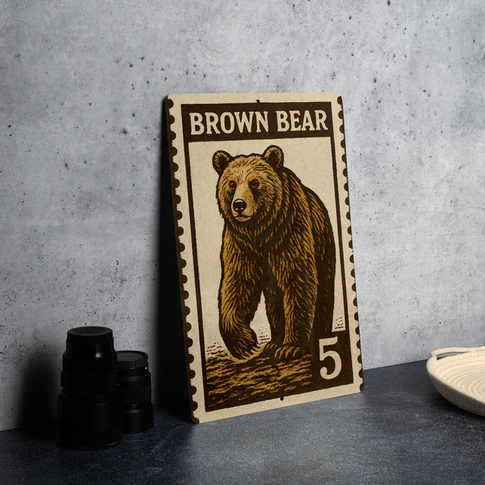 A brown bear stamp with the number 5 on it, placed on a table next to some black camera lenses.