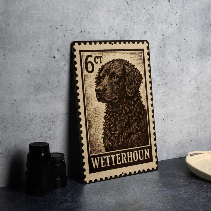 A metal stamp featuring a dog's portrait, with the text "WETTERHOUN" printed on it.