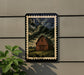 a wooden barn with a cloudy sky in the background, mounted on a wall.