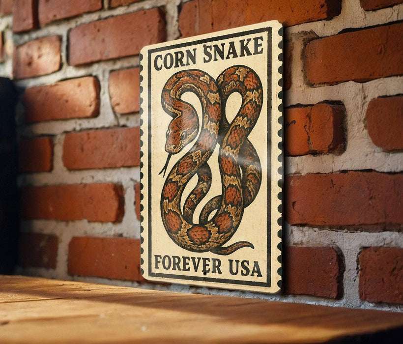 a sign with a large illustration of a corn snake on a brick wall.