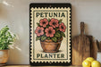 A framed poster of a potted plant with pink flowers, titled "PETUNIA PLANTER", is displayed on a shelf next to a wooden cutting board and some kitchen utensils.