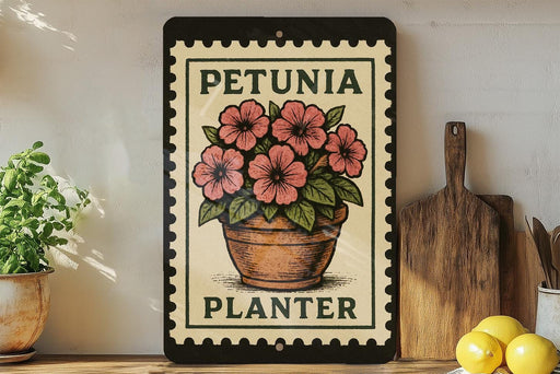 A framed poster of a potted plant with pink flowers, titled "PETUNIA PLANTER", is displayed on a shelf next to a wooden cutting board and some kitchen utensils.