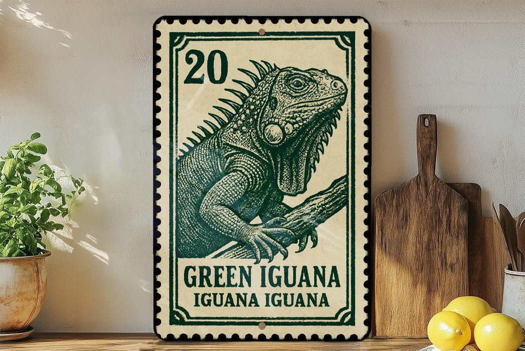 A green and white postage stamp featuring a detailed illustration of a green iguana, with the text "Green Iguana" and "Green Iguana" printed on it. The stamp is placed on a wooden surface, with a potted plant, a wooden cutting board, and some lemons nearby.