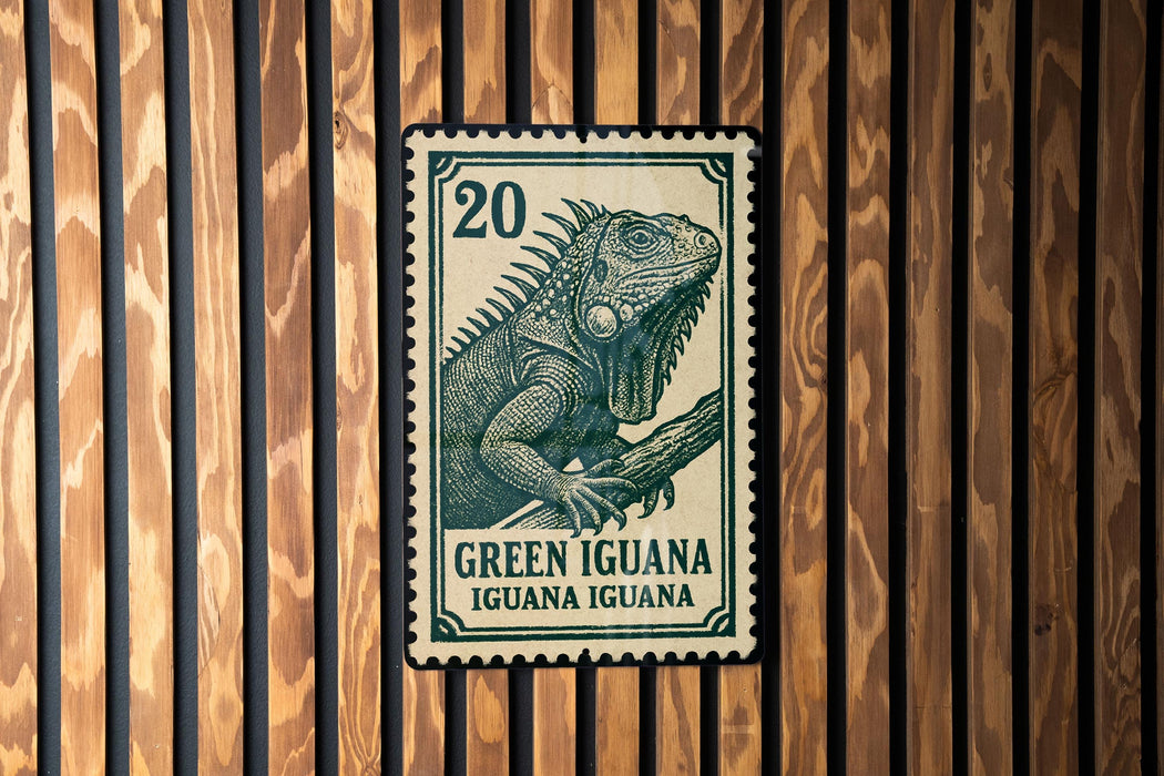 A green and white postage stamp featuring an illustration of a green iguana, mounted on a wooden wall.