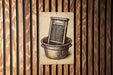 A sign with an illustration of a washing machine or loom in a bucket, mounted on a wooden wall.