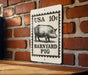 A sign on a brick wall that reads "USA 10¢ Barnyard Pig".