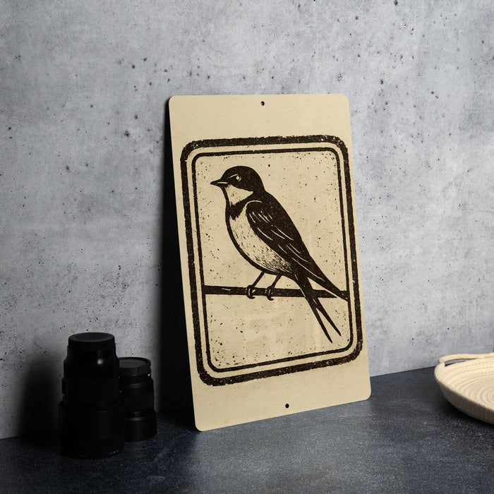 a sign with a black and white illustration of a bird perched on a branch.