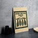a sign with the text "Herb Drying Rack" and illustrations of dried herbs hanging from a rack.