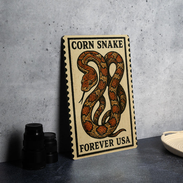 a wooden sign with a snake design, placed on a table next to some black camera lenses.