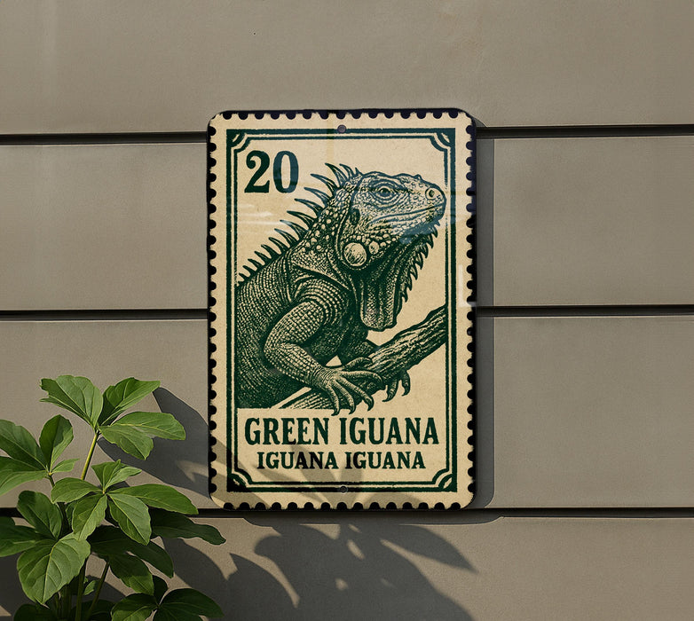 A green and white postage stamp featuring a large green iguana, mounted on a wall next to a plant.
