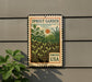 A vintage-style stamp-like sign with a garden scene and the text "SPROUT GARDEN" and "FREVER USA" displayed on a wall.