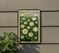 a sign for a white flower garden, with a green border and white flowers depicted on the sign.
