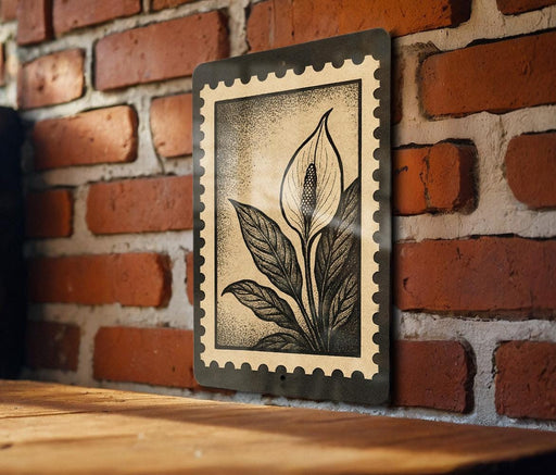A framed illustration of a flower is hanging on a brick wall.