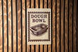 A sign that reads "DOUGH BOWL" is displayed on a wooden wall.