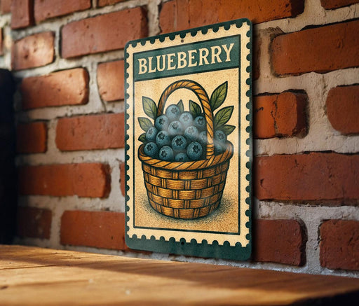 A vintage-style metal sign with a basket of blueberries mounted on a brick wall.