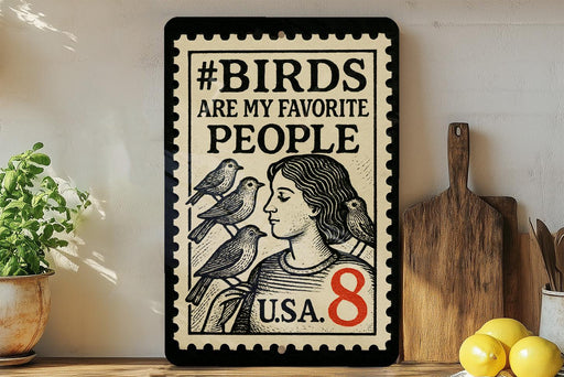 A framed poster with the text "#BIDS ARE MY FAVORITE PEOPLE" and an illustration of a woman with birds perched on her shoulders.