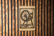a wooden wall with a sign depicting a spinning wheel.
