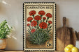 A vintage-style stamp featuring a vibrant illustration of red carnation flowers, with the text "CARNATION BED" and a denomination of 5 cents. The stamp is displayed on a shelf next to a wooden cutting board and a potted plant.